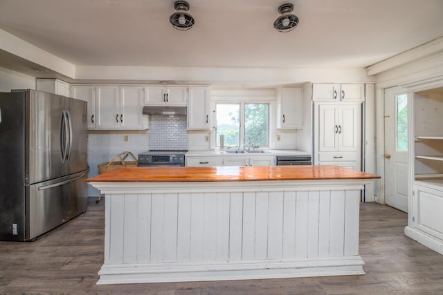 1785 Alna Rd, Alna, ME 04535 - kitchen with stainless steel appliances, wooden counters, under cabinet range hood, white cabinetry, and dark wood-style flooring