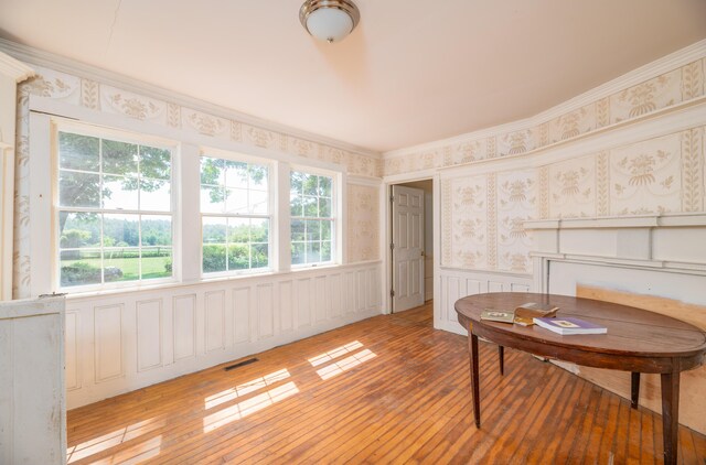 1785 Alna Rd, Alna, ME 04535 - living area with a wainscoted wall, plenty of natural light, light wood-style flooring, wallpapered walls, and crown molding