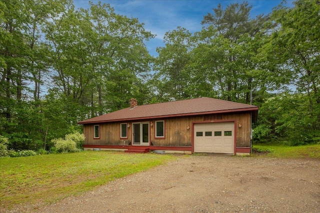 404 Lower Round Pond Rd, Bristol, ME 04539 - single story home featuring dirt driveway, a chimney, a garage, a front yard, and view of wooded area