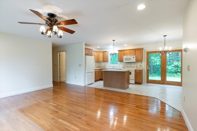 404 Lower Round Pond Rd, Bristol, ME 04539 - kitchen with white appliances, a kitchen island, open floor plan, light countertops, and recessed lighting