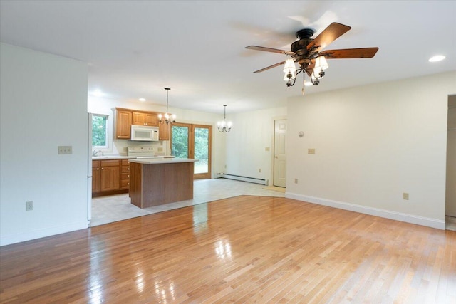 404 Lower Round Pond Rd, Bristol, ME 04539 - unfurnished living room with a chandelier, a baseboard radiator, light wood-style flooring, healthy amount of natural light, and recessed lighting