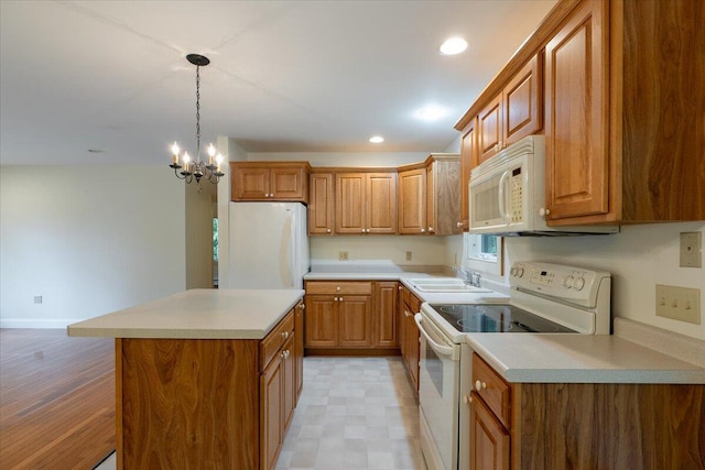 404 Lower Round Pond Rd, Bristol, ME 04539 - kitchen with white appliances, brown cabinetry, a center island, light countertops, and recessed lighting