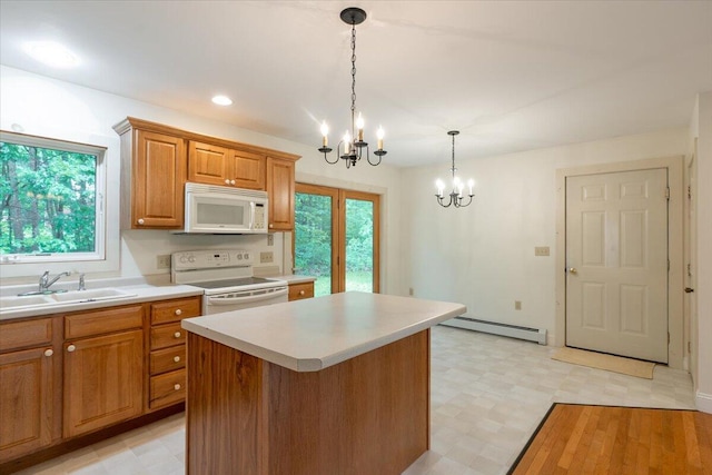 404 Lower Round Pond Rd, Bristol, ME 04539 - kitchen with white appliances, a baseboard heating unit, a chandelier, light countertops, and plenty of natural light