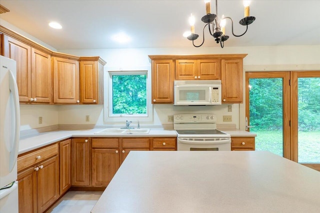 404 Lower Round Pond Rd, Bristol, ME 04539 - kitchen featuring white appliances, light countertops, a chandelier, hanging light fixtures, and brown cabinets