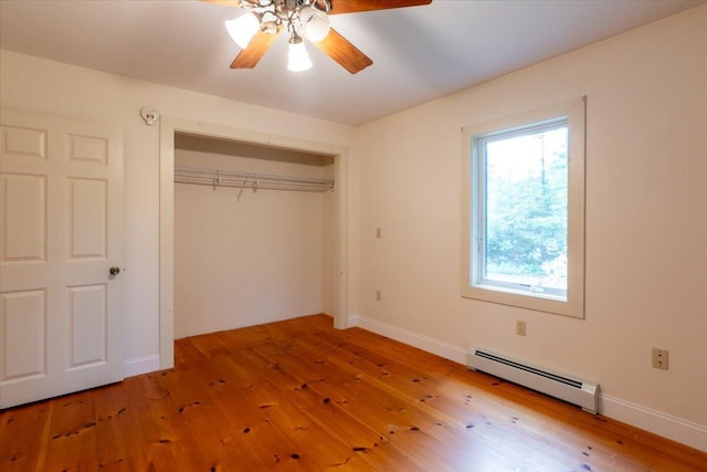 404 Lower Round Pond Rd, Bristol, ME 04539 - unfurnished bedroom with baseboard heating, hardwood / wood-style flooring, a closet, and ceiling fan