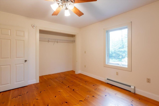 404 Lower Round Pond Rd, Bristol, ME 04539 - unfurnished bedroom with baseboard heating, hardwood / wood-style floors, a closet, and a ceiling fan