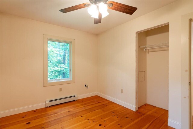 404 Lower Round Pond Rd, Bristol, ME 04539 - unfurnished bedroom featuring baseboard heating, light wood-type flooring, a closet, and a ceiling fan