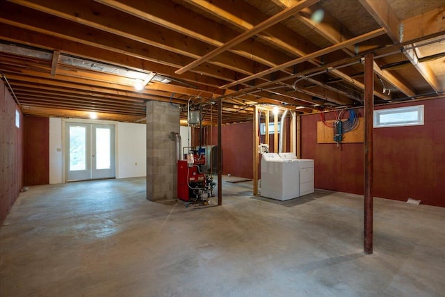 404 Lower Round Pond Rd, Bristol, ME 04539 - basement with washer and clothes dryer, a heating unit, plenty of natural light, and french doors