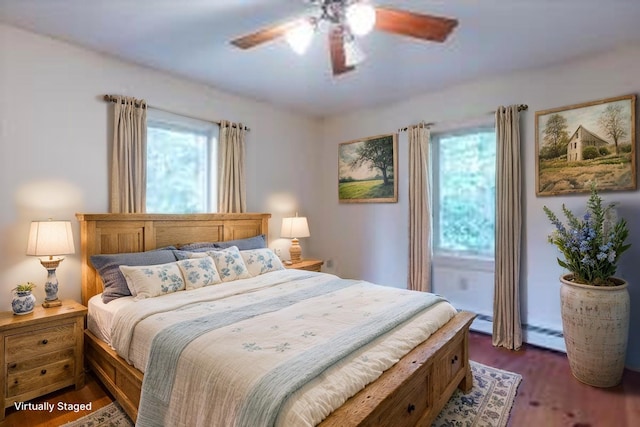 404 Lower Round Pond Rd, Bristol, ME 04539 - bedroom featuring a baseboard heating unit, dark wood-type flooring, and a ceiling fan