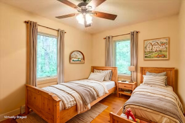 404 Lower Round Pond Rd, Bristol, ME 04539 - bedroom with multiple windows, wood finished floors, and ceiling fan