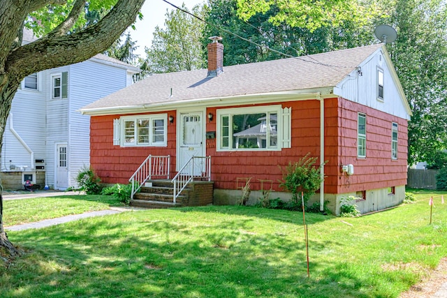 213 Mussey St, South Portland, ME 04106 - bungalow-style home with roof with shingles, a chimney, a front lawn, and entry steps