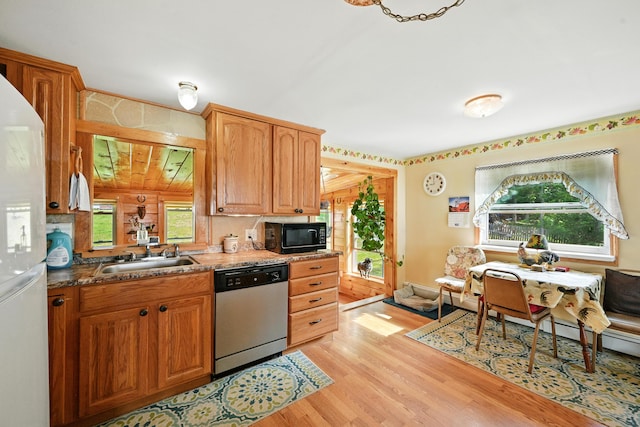 821 China Rd, Albion, ME 04910 - kitchen featuring stainless steel dishwasher, black microwave, white refrigerator with ice dispenser, and light wood-type flooring