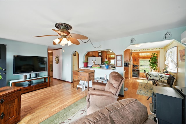 821 China Rd, Albion, ME 04910 - living area featuring a ceiling fan, arched walkways, and light wood finished floors
