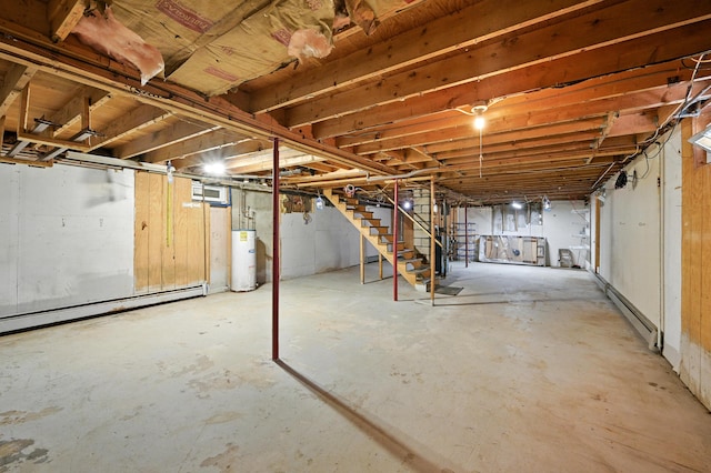 821 China Rd, Albion, ME 04910 - unfinished basement with stairway, water heater, and a baseboard heating unit