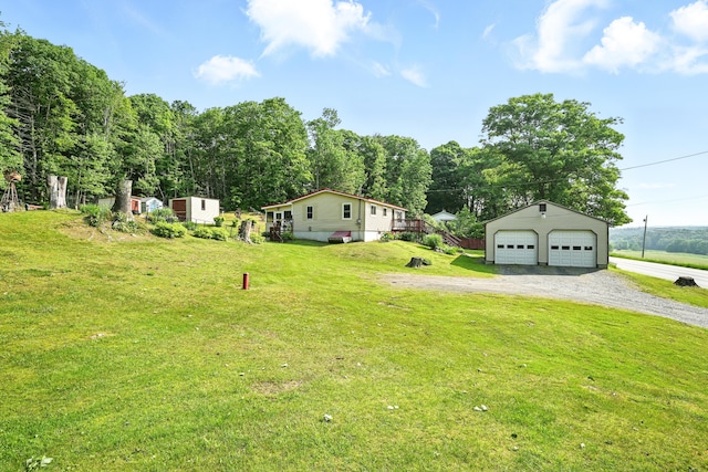 821 China Rd, Albion, ME 04910 - view of grassy yard featuring an outbuilding and a detached garage
