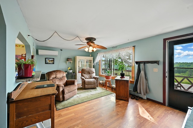 821 China Rd, Albion, ME 04910 - living area featuring a wall unit AC, ceiling fan, and wood finished floors