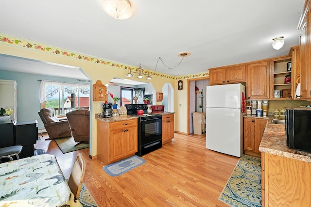 821 China Rd, Albion, ME 04910 - kitchen featuring freestanding refrigerator, black range with electric stovetop, light wood-style flooring, open shelves, and arched walkways