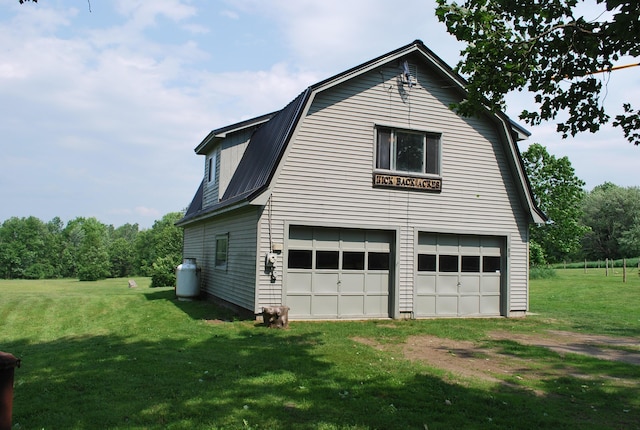 180 Chadbourne Rd, Harmony, ME 04942 - view of home's exterior featuring a gambrel roof, dirt driveway, and a lawn