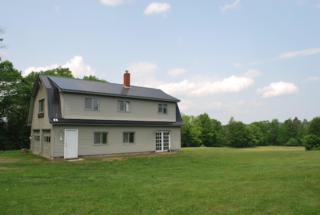 180 Chadbourne Rd, Harmony, ME 04942 - back of property with a chimney, a yard, a metal roof, and a gambrel roof