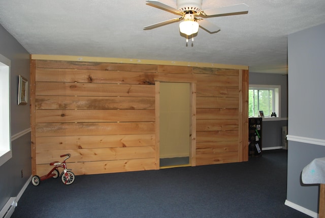 180 Chadbourne Rd, Harmony, ME 04942 - carpeted spare room with a baseboard heating unit and ceiling fan