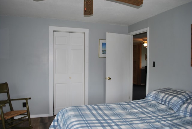 180 Chadbourne Rd, Harmony, ME 04942 - bedroom with dark wood-type flooring, a closet, and a ceiling fan