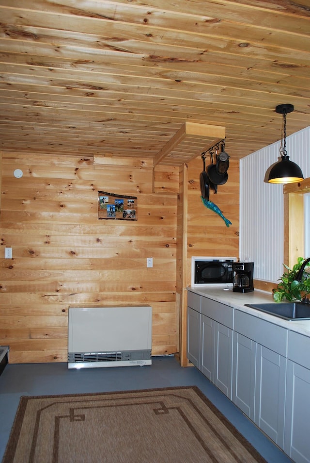 180 Chadbourne Rd, Harmony, ME 04942 - kitchen featuring black microwave, wood ceiling, wooden walls, decorative light fixtures, and concrete flooring