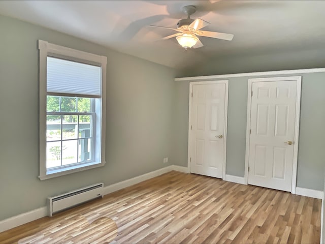 32 Low Hill Ln, Fletchers Landing Twp, ME 04605 - unfurnished bedroom with baseboard heating, light wood-style floors, and a ceiling fan