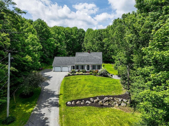 3350 Middle Rd, Sidney, ME 04330 - view of front of home with asphalt driveway, a garage, a front yard, a view of trees, and a chimney