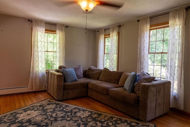 3350 Middle Rd, Sidney, ME 04330 - living room featuring baseboard heating, ceiling fan, and light wood-type flooring