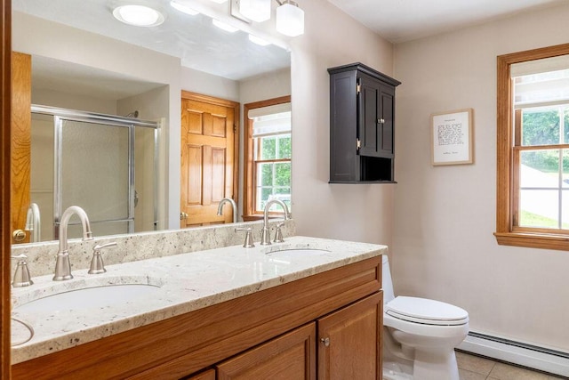 3350 Middle Rd, Sidney, ME 04330 - bathroom featuring baseboard heating, a stall shower, double vanity, and tile patterned flooring