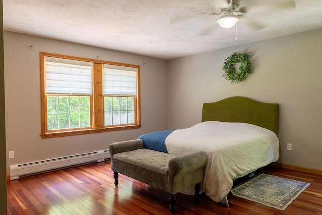 3350 Middle Rd, Sidney, ME 04330 - bedroom with a baseboard heating unit, wood finished floors, and a ceiling fan