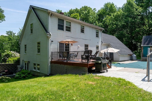 3350 Middle Rd, Sidney, ME 04330 - rear view of property featuring a wooden deck, a lawn, a chimney, a patio area, and a storage shed