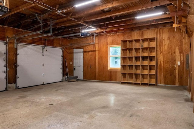 3350 Middle Rd, Sidney, ME 04330 - garage with wood walls and a garage door opener