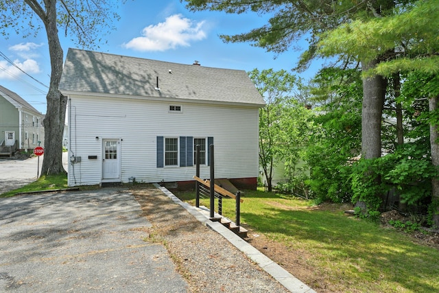 14 Maple St, Lisbon, ME 04252 - rear view of house featuring a lawn, a shingled roof, and driveway