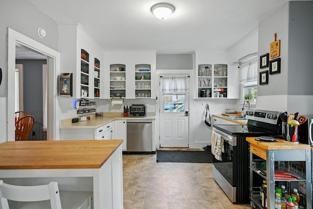14 Maple St, Lisbon, ME 04252 - kitchen featuring appliances with stainless steel finishes, butcher block counters, glass insert cabinets, white cabinetry, and open shelves