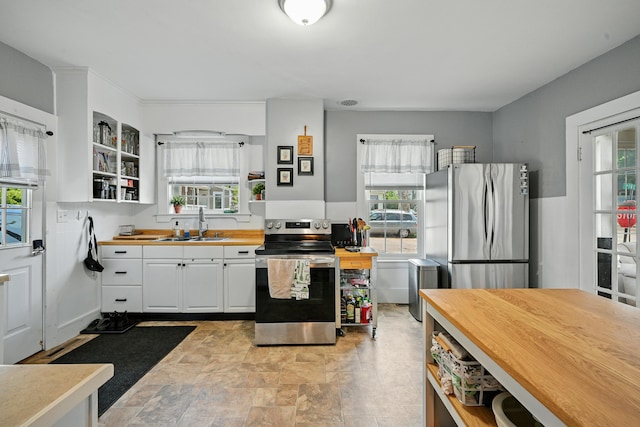 14 Maple St, Lisbon, ME 04252 - kitchen featuring appliances with stainless steel finishes, healthy amount of natural light, butcher block counters, and white cabinetry