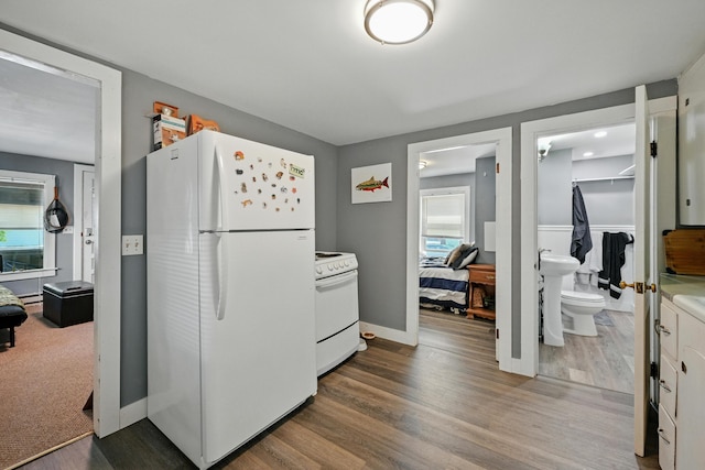 14 Maple St, Lisbon, ME 04252 - kitchen featuring white appliances, dark wood-style floors, light countertops, and a baseboard radiator