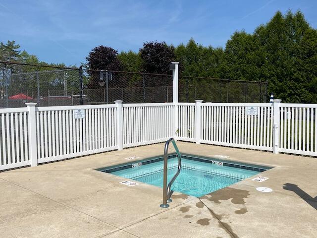 1072 Post Rd Unit 102, Wells, ME 04090 - view of swimming pool featuring a hot tub and a patio area