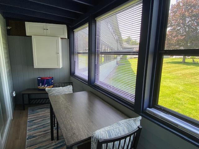 1072 Post Rd Unit 102, Wells, ME 04090 - dining space featuring plenty of natural light, wood finished floors, and wooden walls