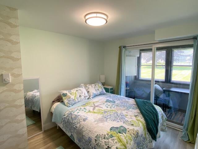 1072 Post Rd Unit 102, Wells, ME 04090 - bedroom with wood finished floors and access to outside