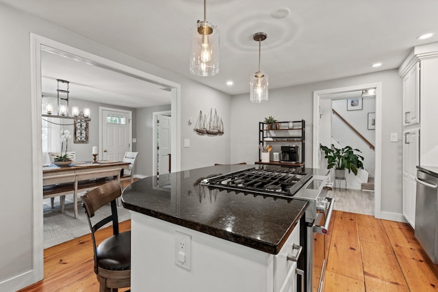 526 E Main St, Yarmouth, ME 04096 - kitchen featuring appliances with stainless steel finishes, light wood-style flooring, a kitchen island, white cabinets, and recessed lighting