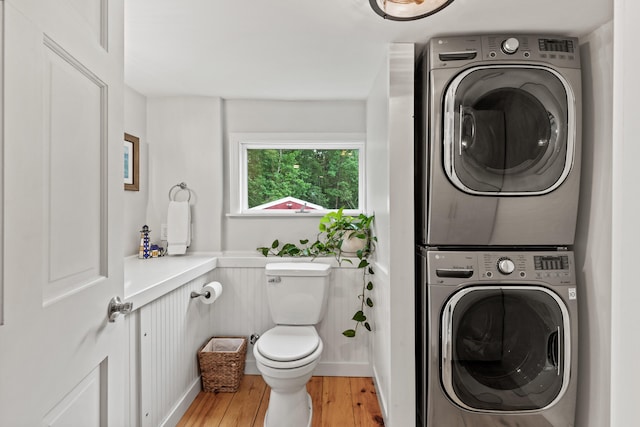 526 E Main St, Yarmouth, ME 04096 - bathroom with stacked washer / drying machine, wood finished floors, and a wainscoted wall