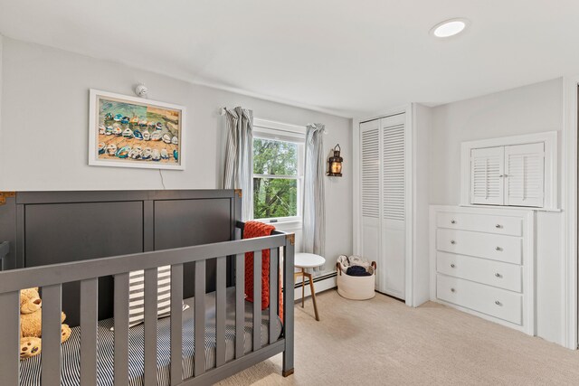 526 E Main St, Yarmouth, ME 04096 - bedroom with carpet, a closet, a baseboard heating unit, and a crib