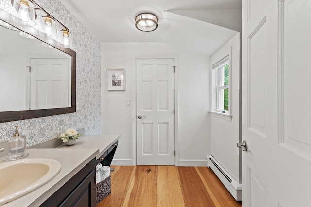 526 E Main St, Yarmouth, ME 04096 - bathroom featuring a baseboard heating unit, vanity, wood finished floors, and lofted ceiling