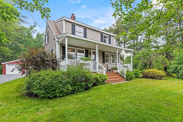 526 E Main St, Yarmouth, ME 04096 - view of front of home with covered porch, a chimney, a front lawn, and a garage