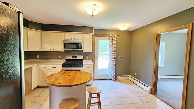 50 George Wright Rd, Woolwich, ME 04579 - kitchen featuring appliances with stainless steel finishes, a baseboard radiator, light tile patterned floors, and wood counters