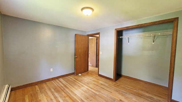 50 George Wright Rd, Woolwich, ME 04579 - unfurnished bedroom featuring baseboard heating, a closet, and light wood finished floors