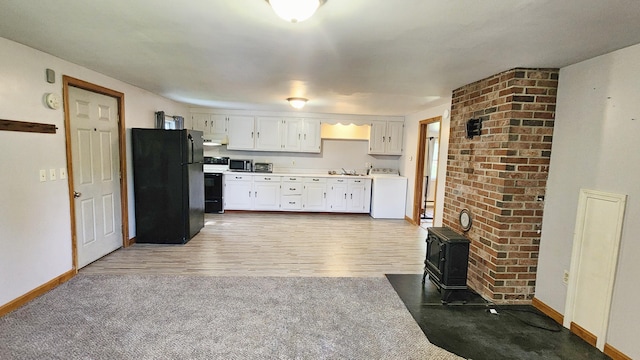 50 George Wright Rd, Woolwich, ME 04579 - kitchen featuring freestanding refrigerator, washer / clothes dryer, white range with electric cooktop, under cabinet range hood, and white cabinetry