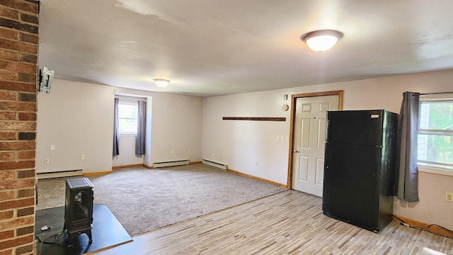 50 George Wright Rd, Woolwich, ME 04579 - unfurnished living room featuring a baseboard radiator, plenty of natural light, and light wood-style flooring