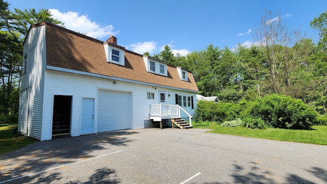 50 George Wright Rd, Woolwich, ME 04579 - colonial inspired home with a gambrel roof, a chimney, a shingled roof, and a garage